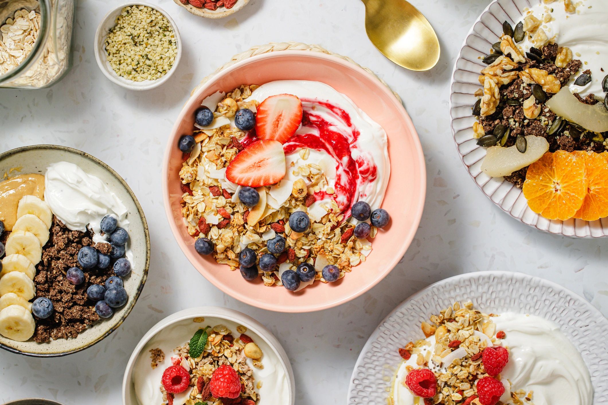 Healthy breakfast bowls with fruit, yogurt, and granola