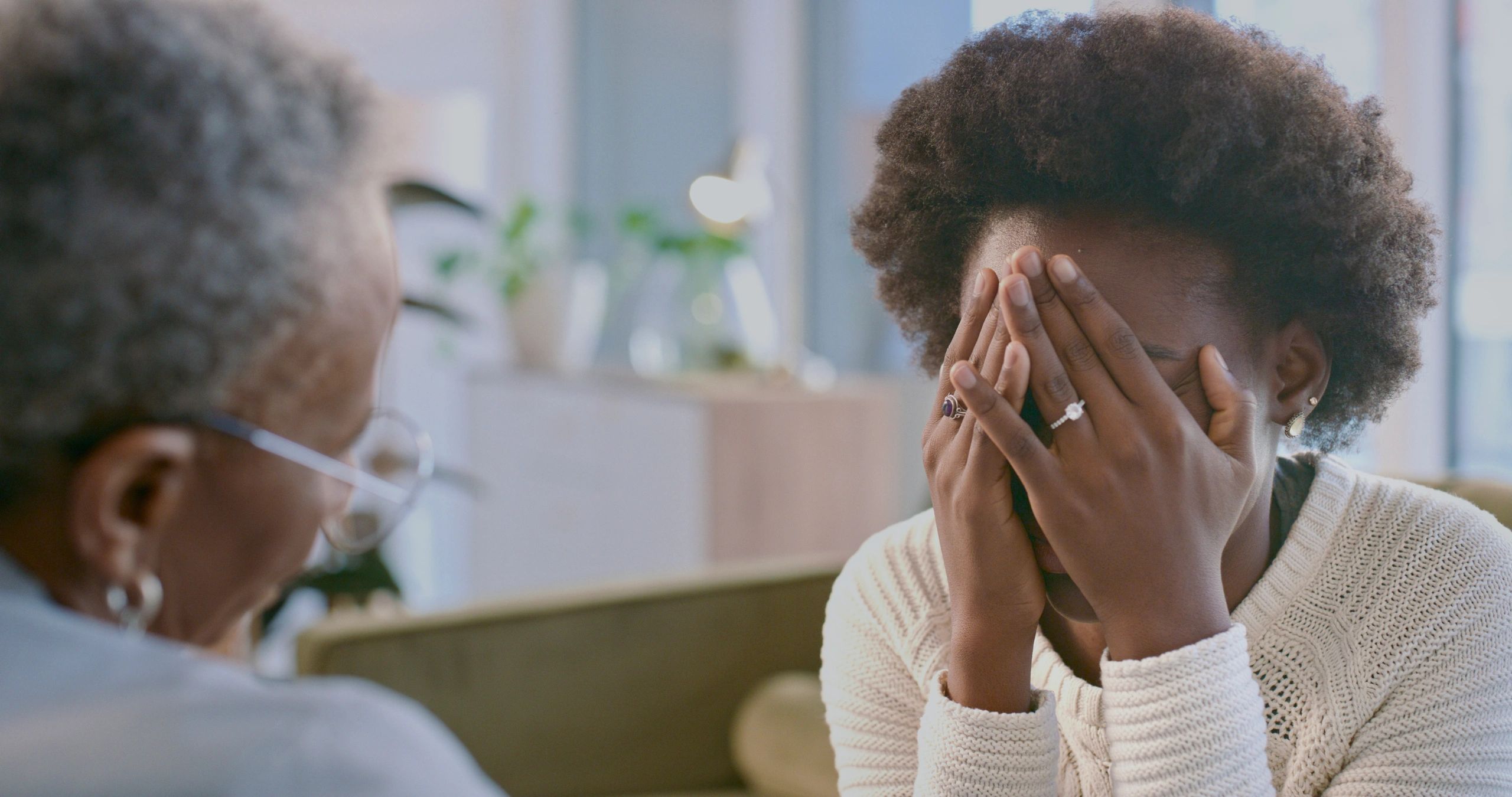 Counselor supporting a woman during a mental health session